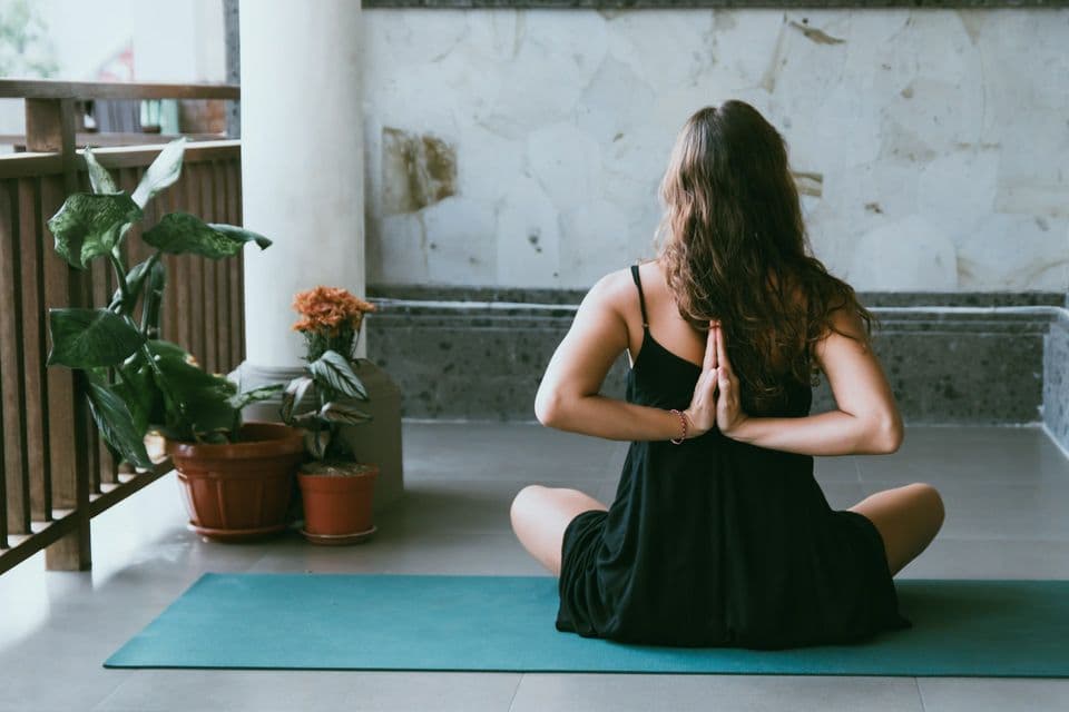 Woman meditating peacefully at home
